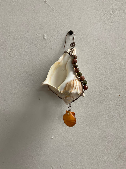 Hanging whelk shell decorated