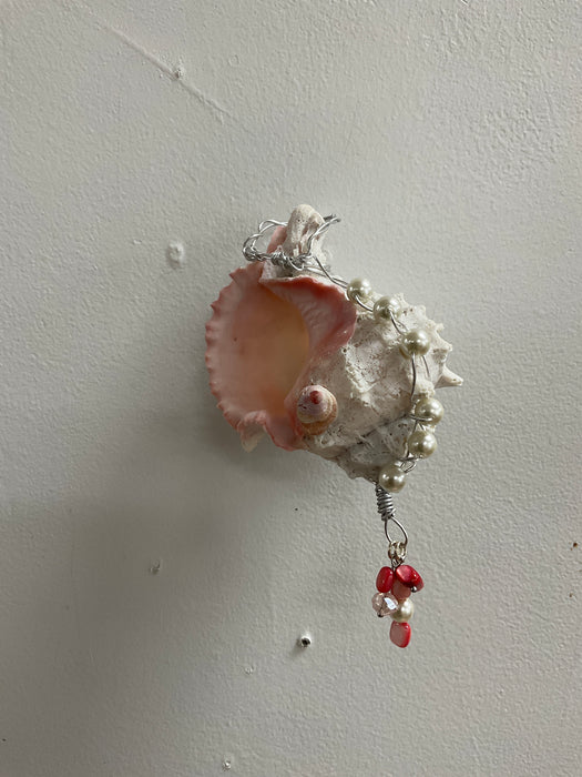 Hanging whelk shell decorated