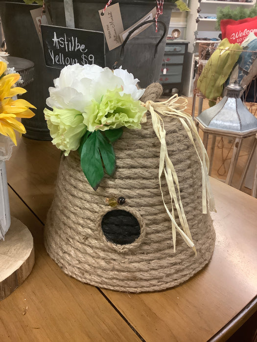 Rope beehive with white and green flowers