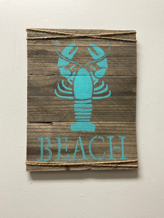 Teal lobster beach sign on wood