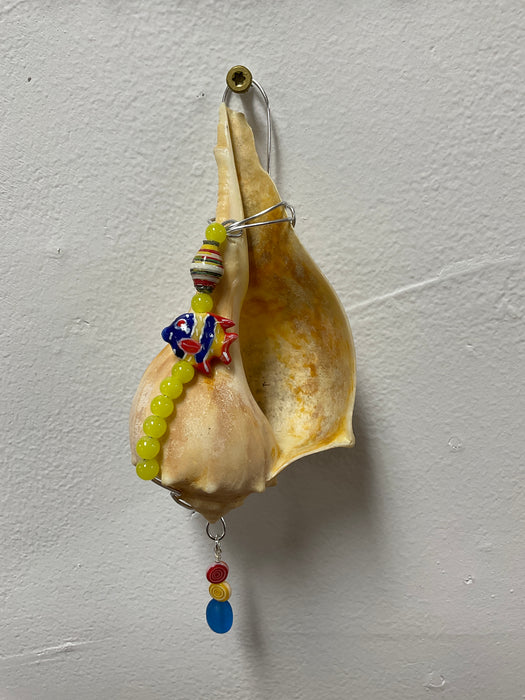 Hanging whelk shell decorated