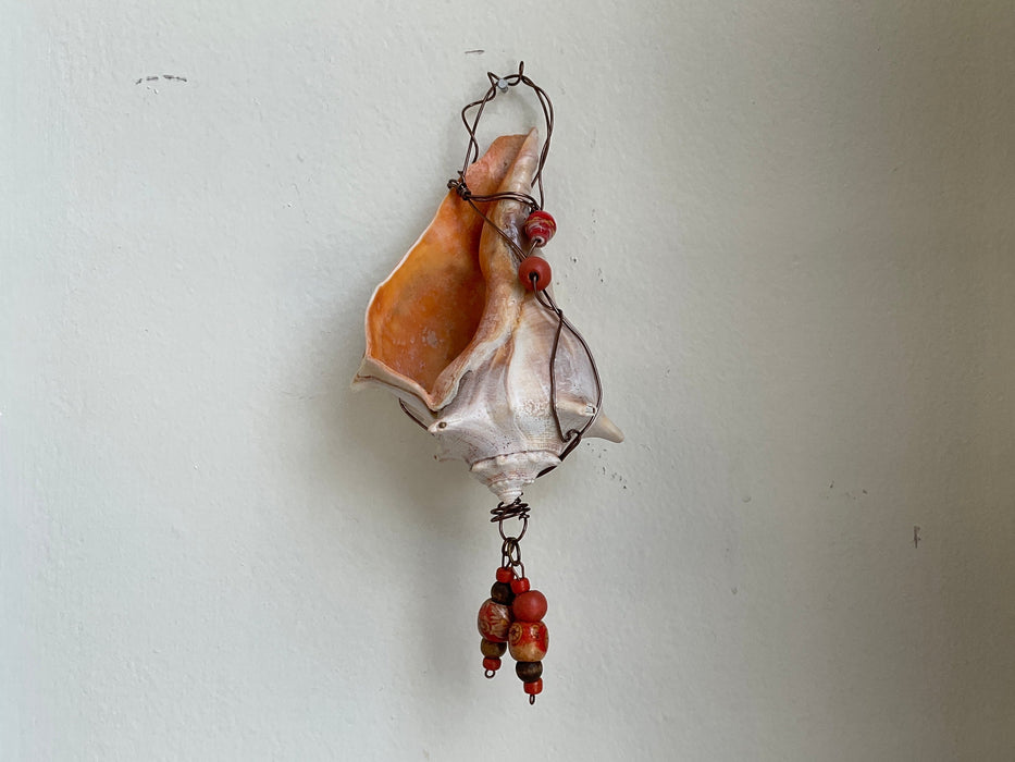 Hanging whelk shell decorated