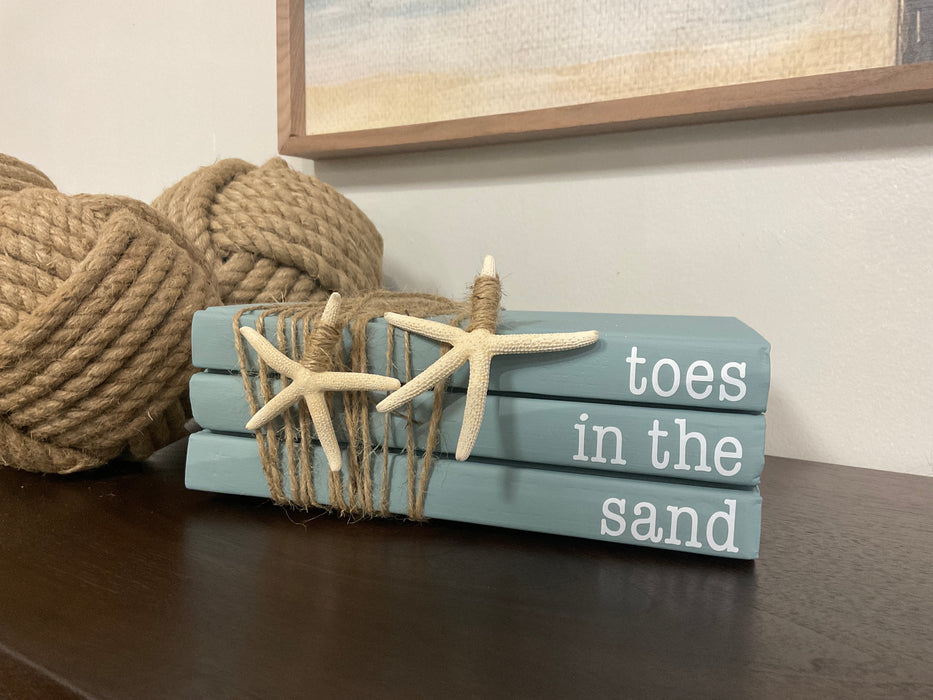 Book stack- toes in the sand