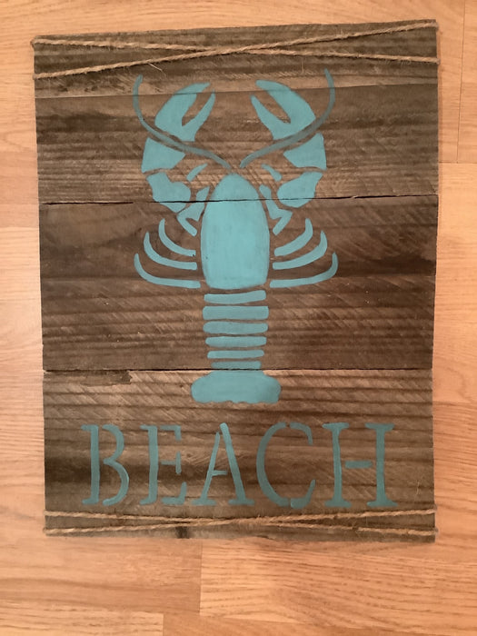 Teal lobster beach sign on wood
