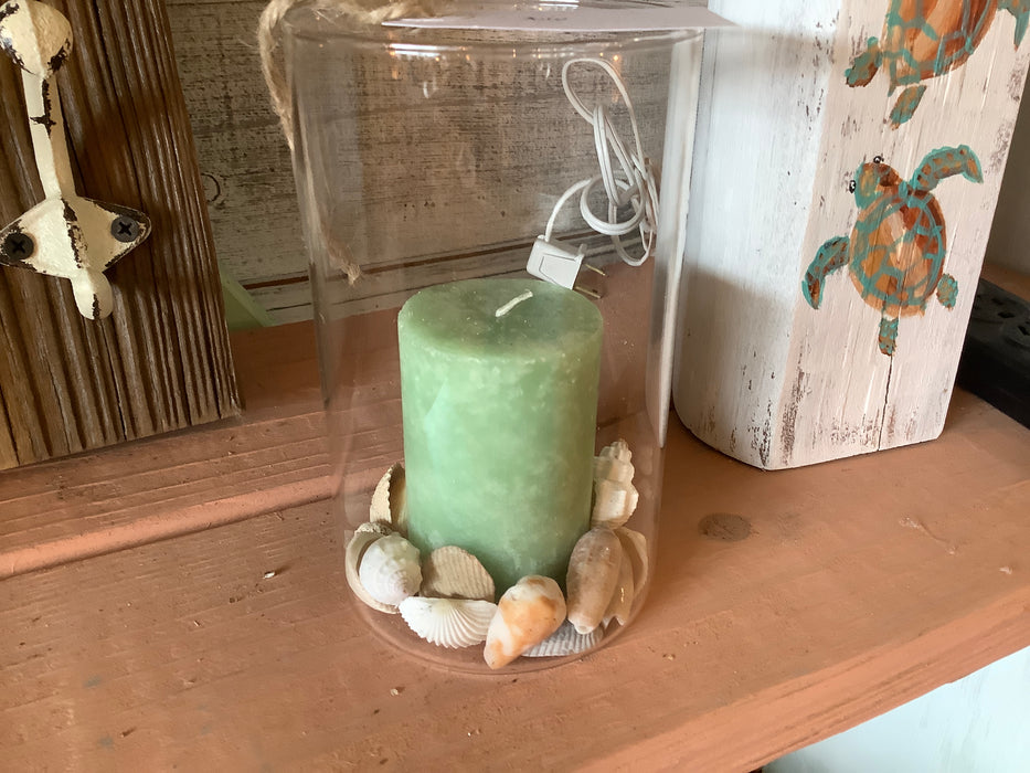 Glass candle holder with shells
