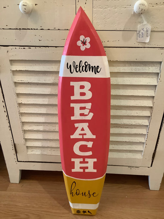 Welcome beach house surfboard