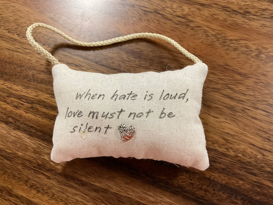 Hanging pillow with written phrase
